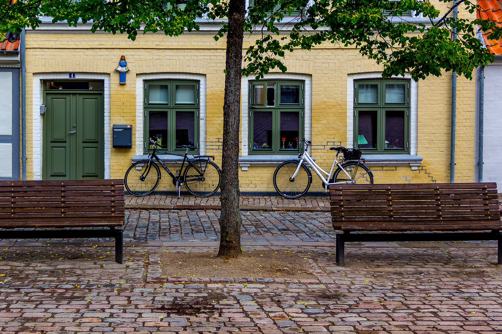 Quiet Odense street scene, with bicycles and a cheery house front, something to see during one day in Odense Denmark.