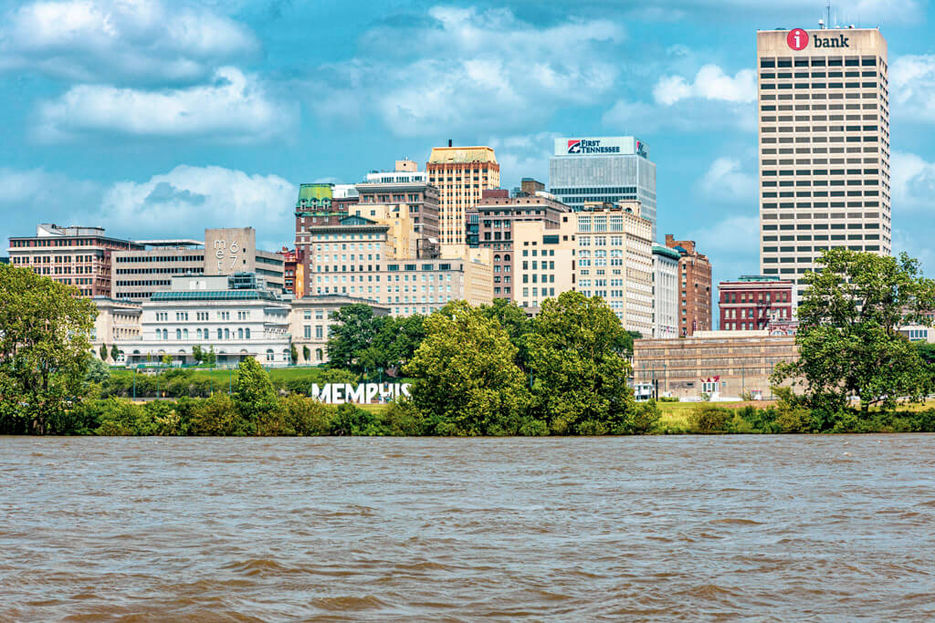 View of the Memphis skyline and city sign as seen from a riverboat on the Mississippi, a fun thing to do during your weekend in Memphis.