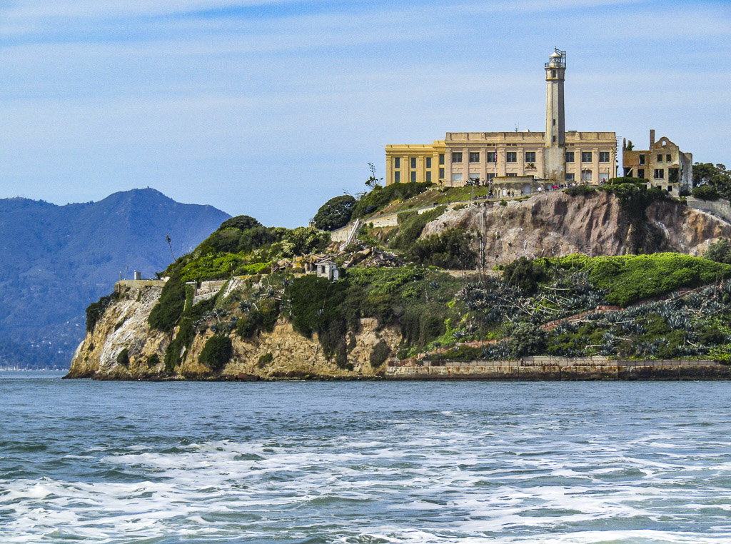 An offset view of Alcatraz Island, with the cliff, prison, and lighthouse, in our attempt to discern, is Alcatraz worth it?