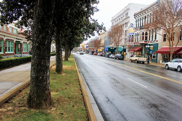 Main street in Hot Springs, Arkansas, with historic buildings and a tree lined avenue, one of the best places to go in Hot Springs.